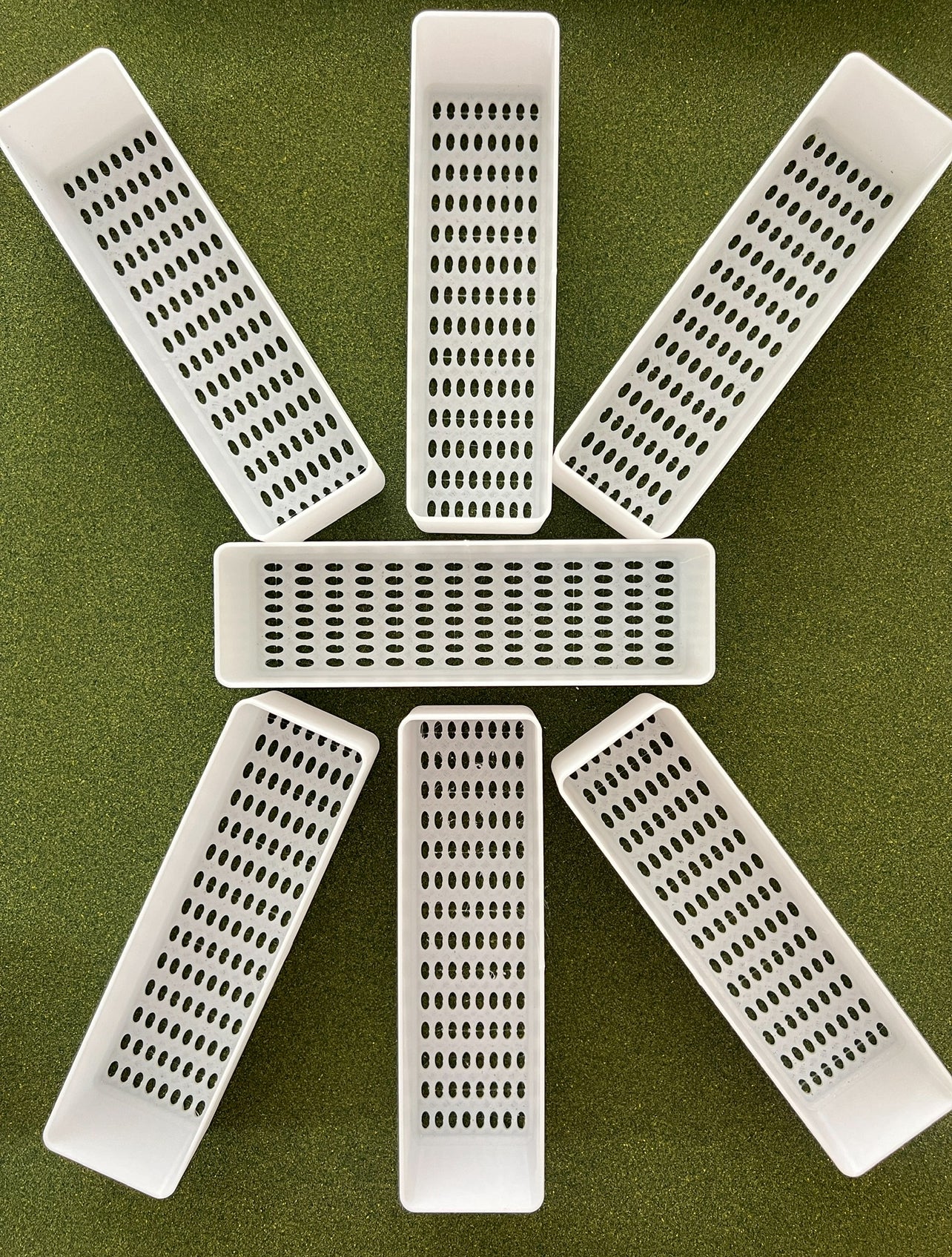 Close-up of planter tray with drainage holes for indoor gardening