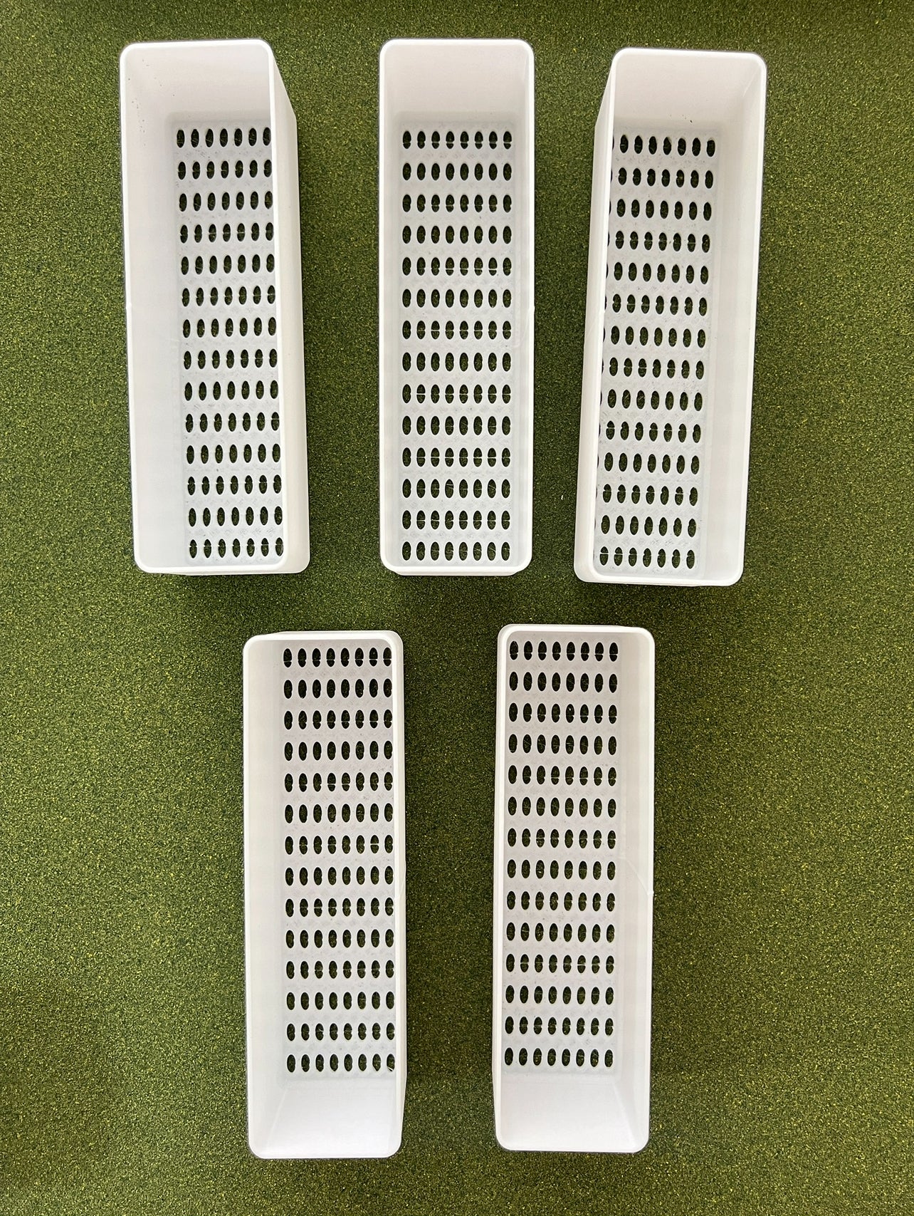 Close-up of planter tray with drainage holes for indoor gardening