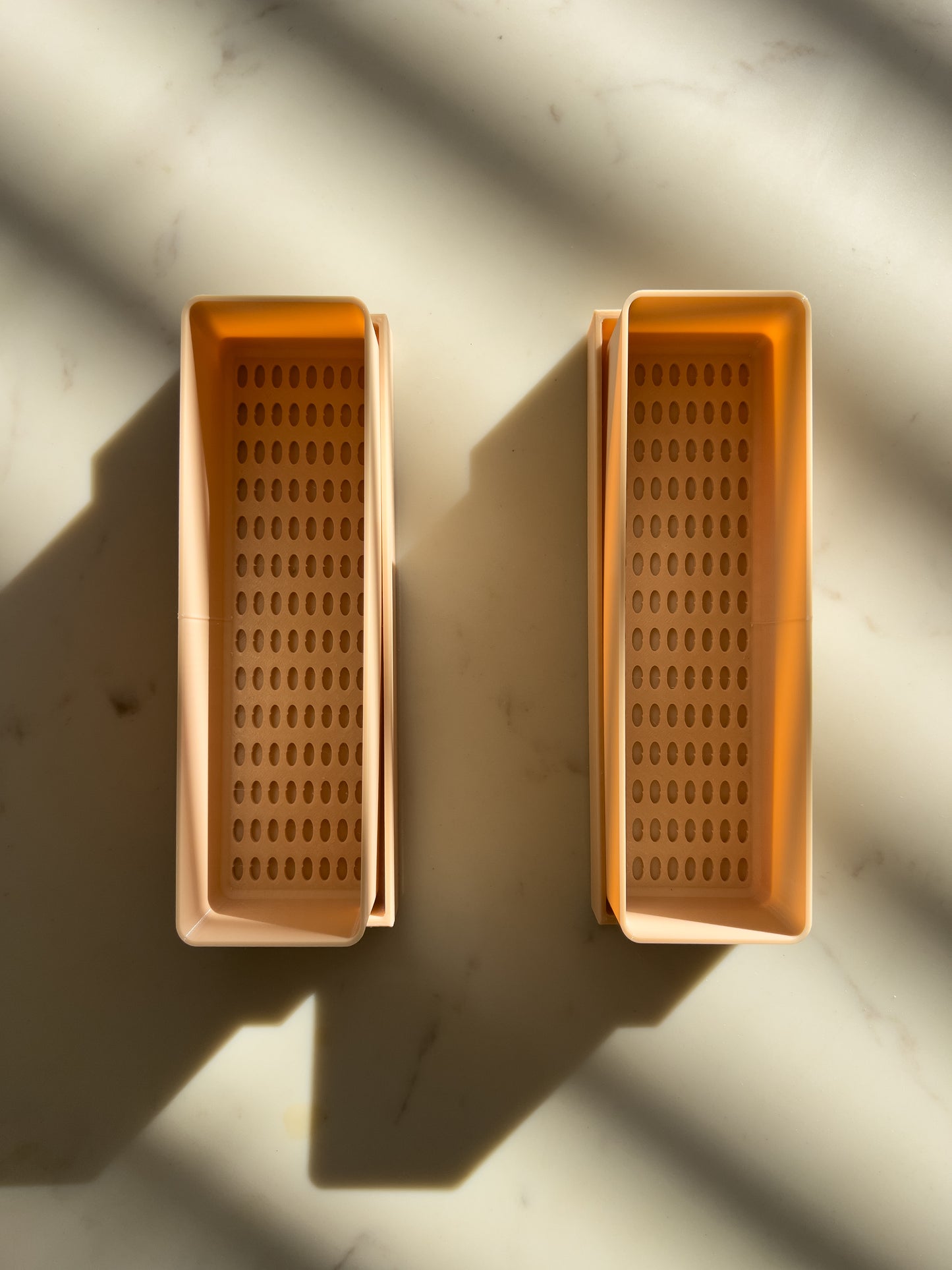 Close-up of planter tray with drainage holes for indoor gardening