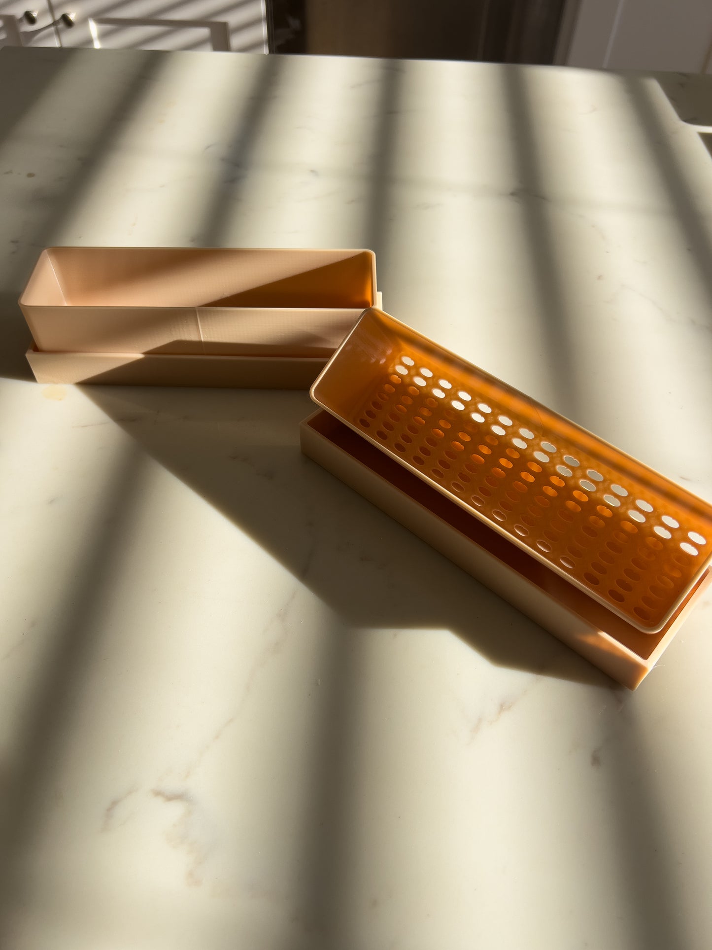 Close-up of planter tray with drainage holes for indoor gardening
