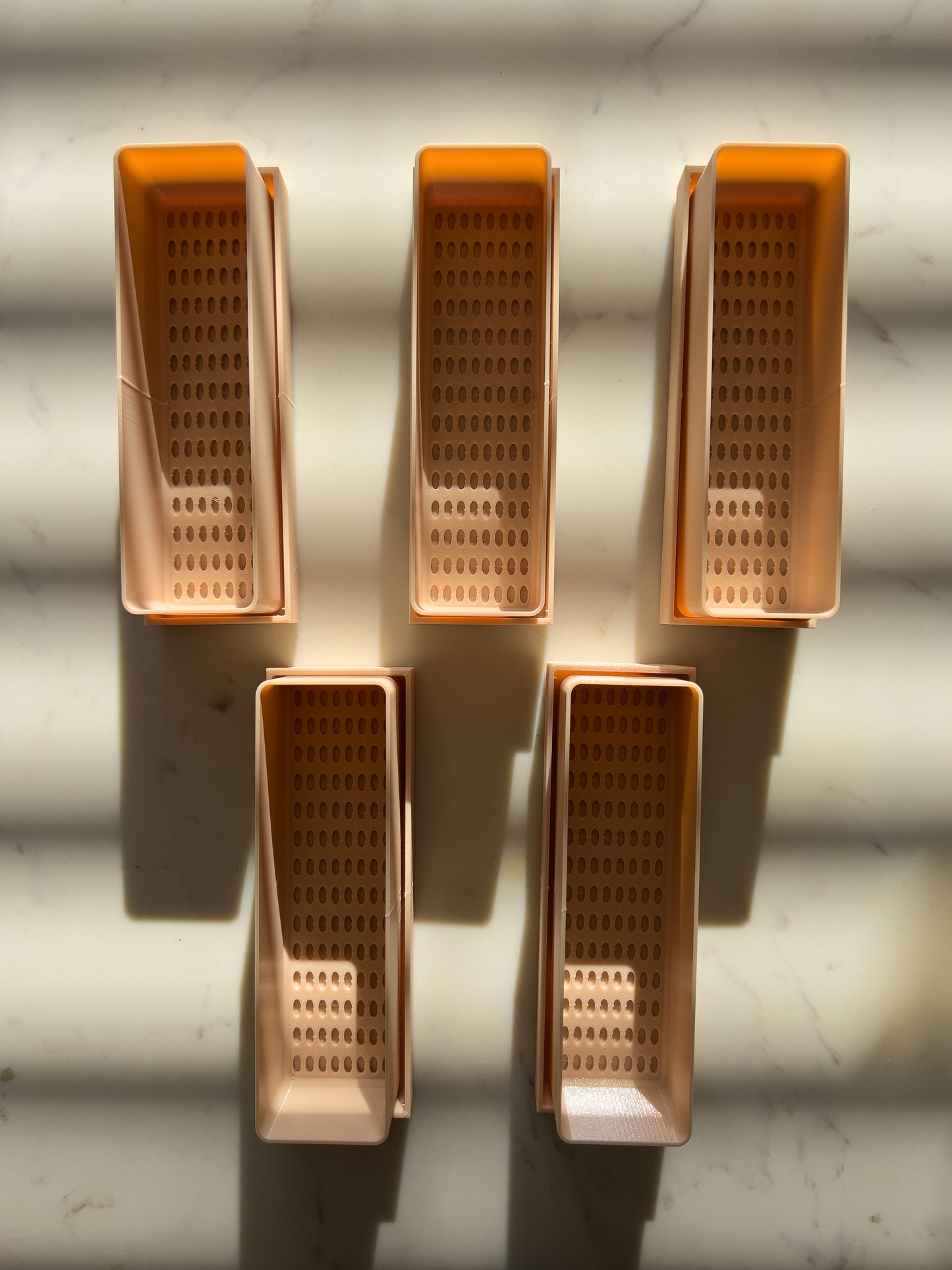 Close-up of planter tray with drainage holes for indoor gardening